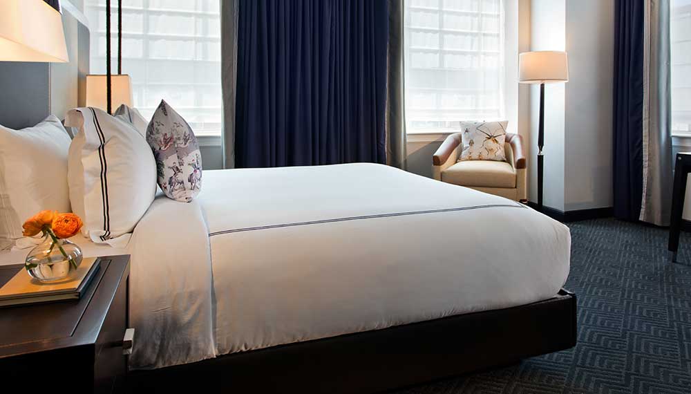 Guestroom with tall ceilings at natural light